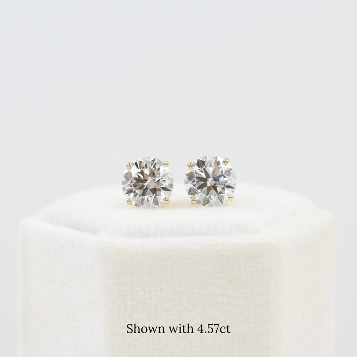 The Classic Stud Earrings in Yellow Gold with 4.57ct Lab-Grown Diamond atop a white velvet ring box