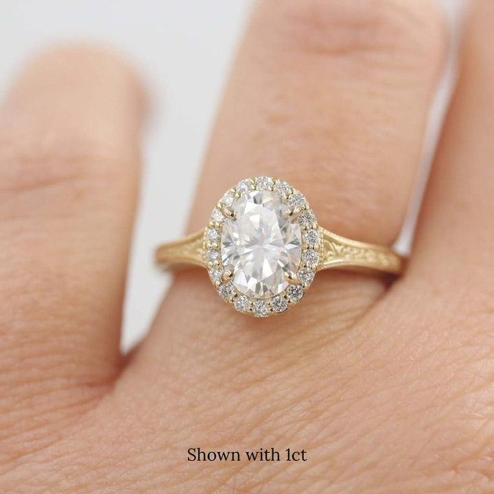 a 1ct oval engagement ring on a finger