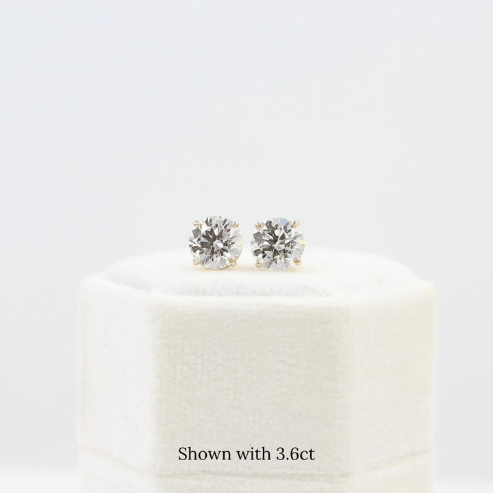 The Classic Stud Earrings in Yellow Gold with 3.6ct Lab-Grown Diamond atop a white velvet ring box