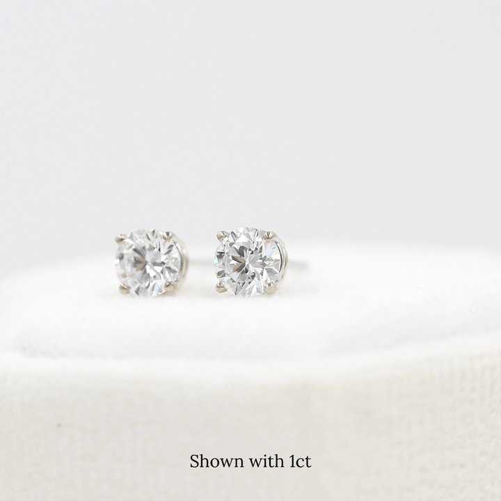 The Classic Stud Earrings in White Gold with 1ct Lab-Grown Diamond atop a white velvet ring box