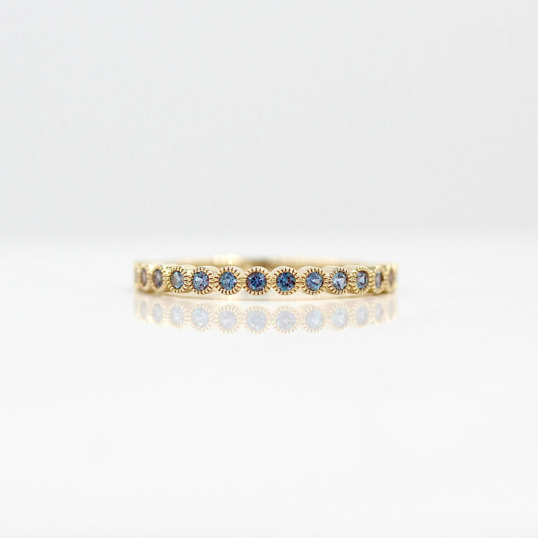 The Florence Wedding Band with Alexandrite in Yellow Gold against a white background