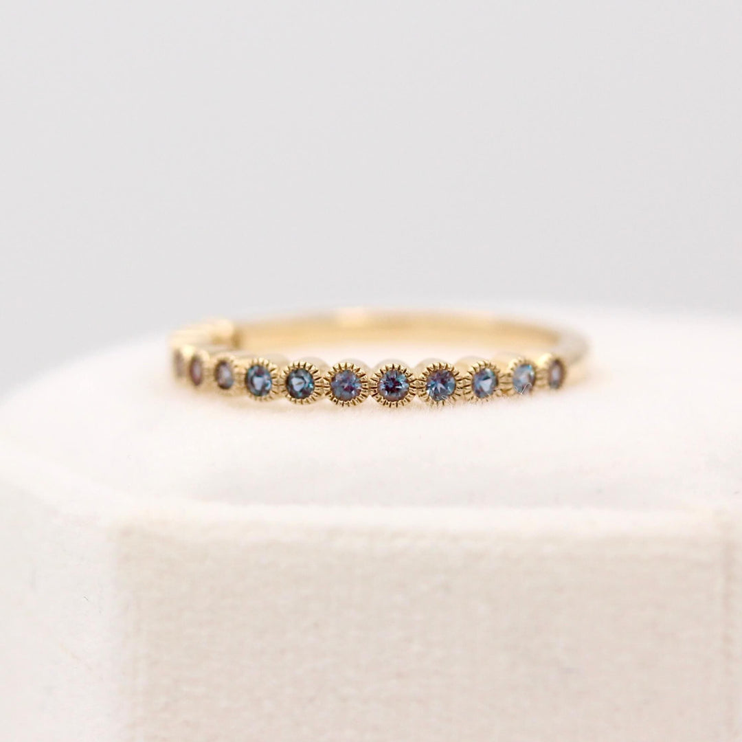 The Florence Wedding Band with Alexandrite in Yellow Gold in a white velvet ring box