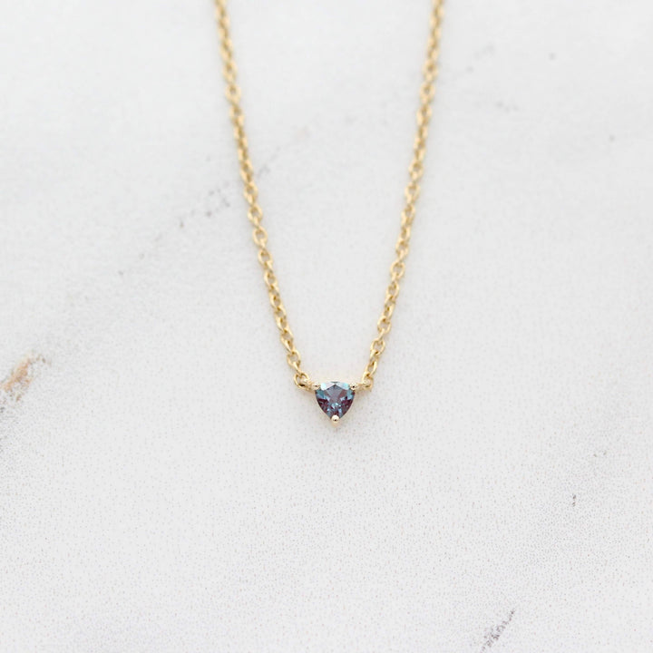 The June Birthstone Tiny Trillion Necklace with Alexandrite in Yellow Gold against a white background