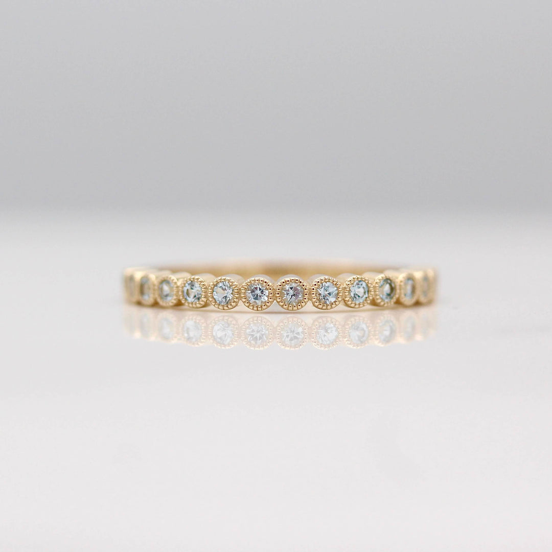 The Florence Wedding Band with Aqua Spinel in Yellow Gold against a white background