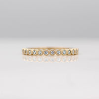 The Florence Wedding Band with Aqua Spinel in Yellow Gold against a white background