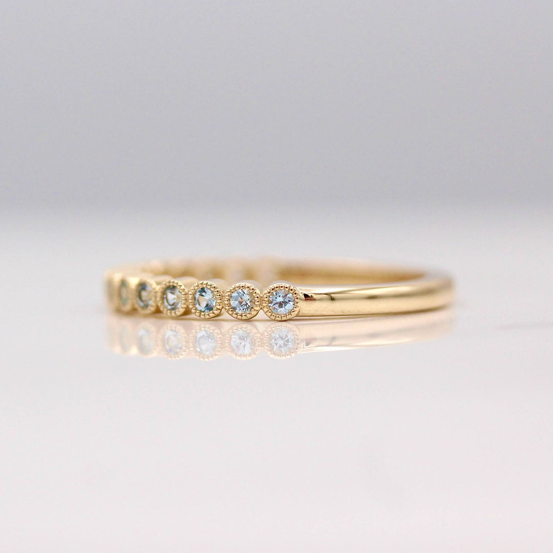 The Florence Wedding Band with Aqua Spinel in Yellow Gold against a white background