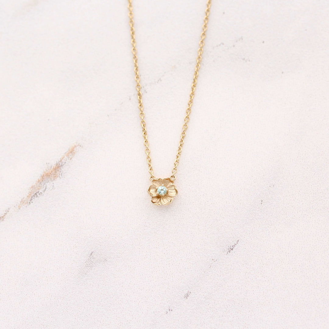 The March Birthstone Poppy Necklace with Aqua Spinel in Yellow Gold against a white background