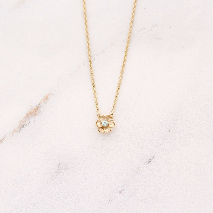 The March Birthstone Poppy Necklace with Aqua Spinel in Yellow Gold against a white background