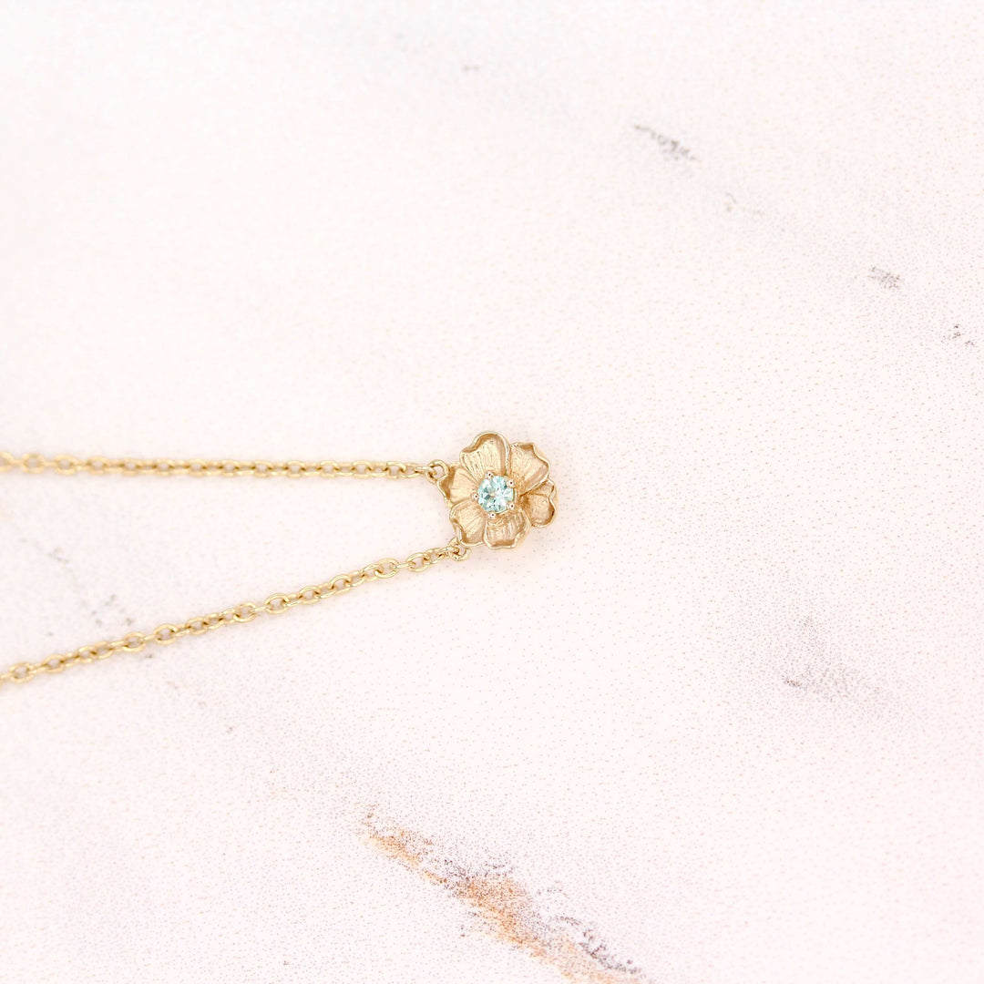 The March Birthstone Poppy Necklace with Aqua Spinel in Yellow Gold against a white background