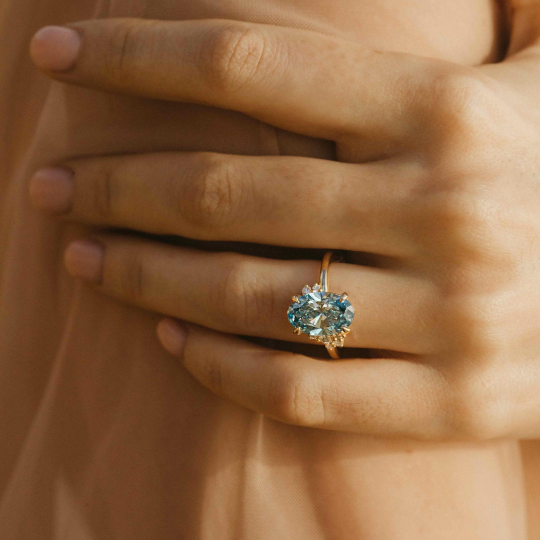 The Bella Ring (Oval) in Yellow Gold with 3.27ct Blue Lab-Grown Diamond modeled on a hand