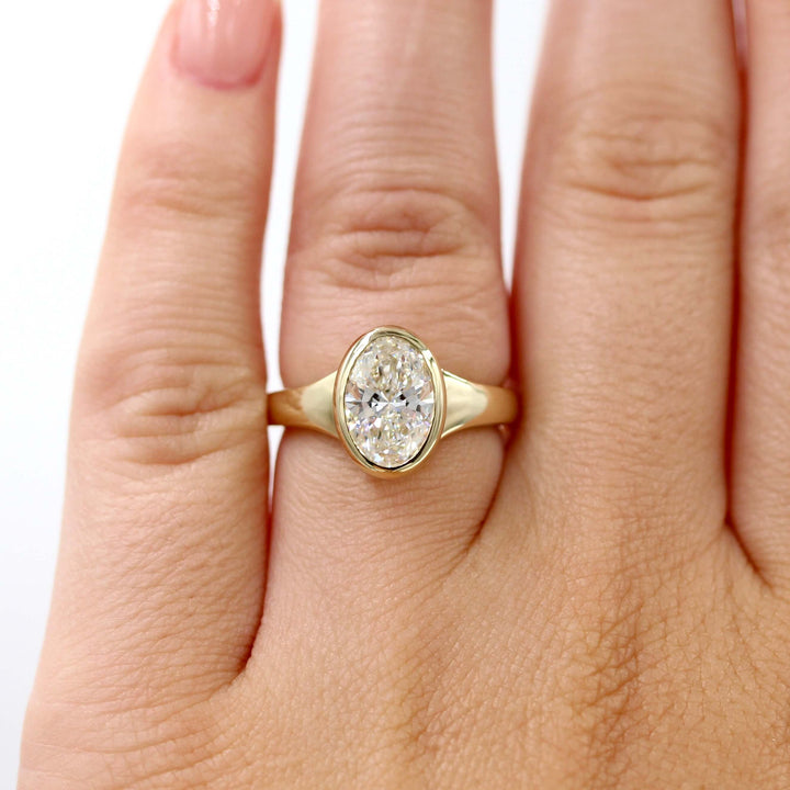 The Billie Ring (Oval) in Yellow Gold with 2ct Lab-Grown Diamond modeled on a hand