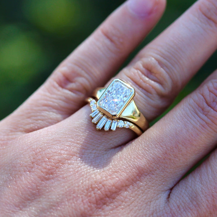 The Billie Ring (Radiant) in Yellow Gold with 2ct LGD stacked with the Sunburst wedding band in yellow gold modeled on a hand