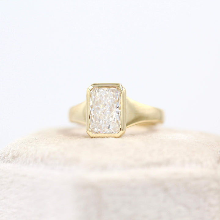 The Billie Ring (Radiant) in Yellow Gold with 2ct LGD atop a white velvet ring box