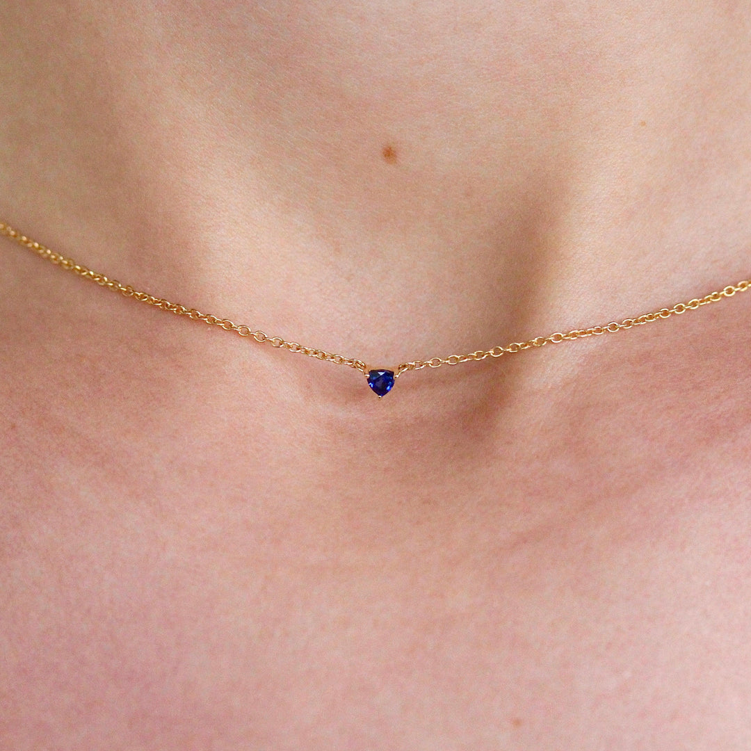 The September Birthstone Tiny Trillion Necklace with Blue Sapphire in Yellow Gold modeled