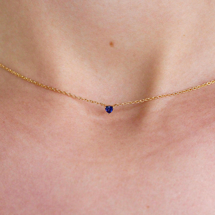 The September Birthstone Tiny Trillion Necklace with Blue Sapphire in Yellow Gold modeled