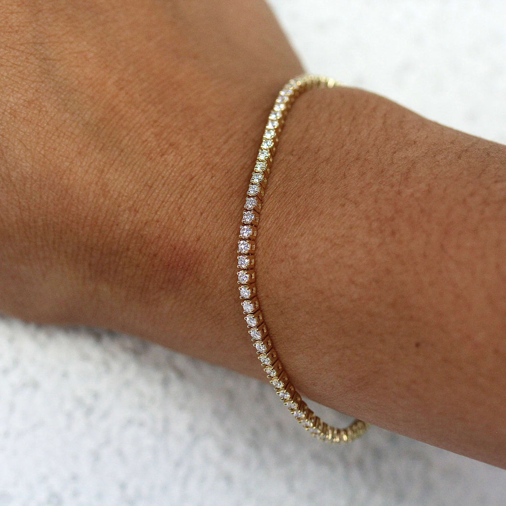 The Classic Lab-Grown Diamond Tennis Bracelet in Yellow Gold modeled on a hand