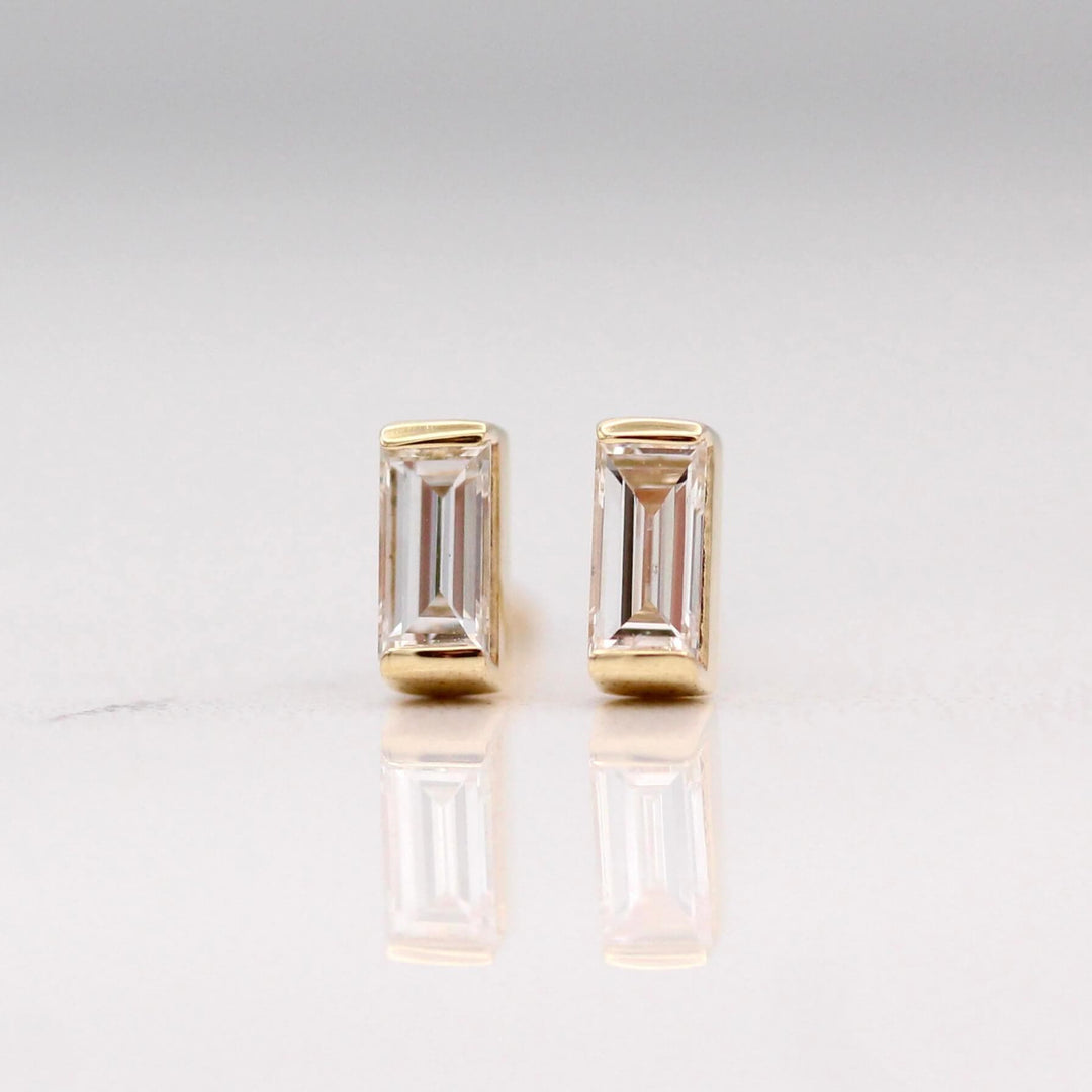 The April Baguette Birthstone Earrings with Lab-Grown Diamond in Yellow Gold against a white background