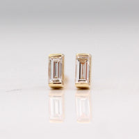 The April Baguette Birthstone Earrings with Lab-Grown Diamond in Yellow Gold against a white background