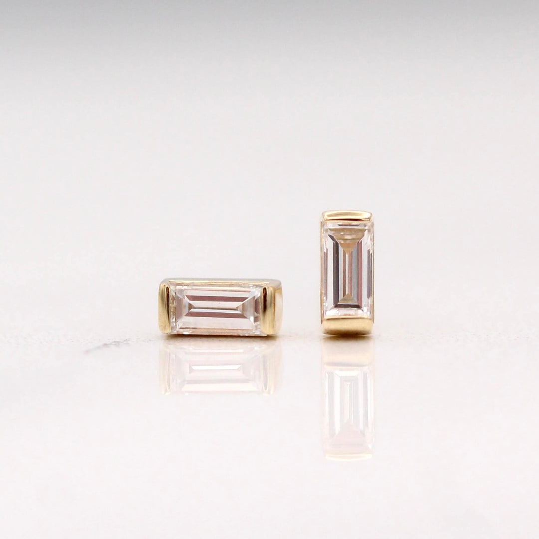 The April Baguette Birthstone Earrings with Lab-Grown Diamond in Yellow Gold against a white background