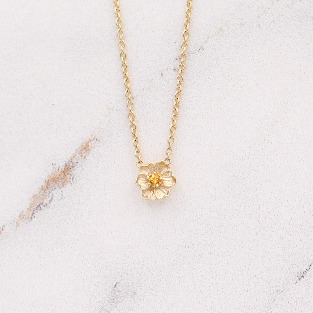 The November Birthstone Poppy Necklace with Gold Sapphire in Yellow Gold against a white background