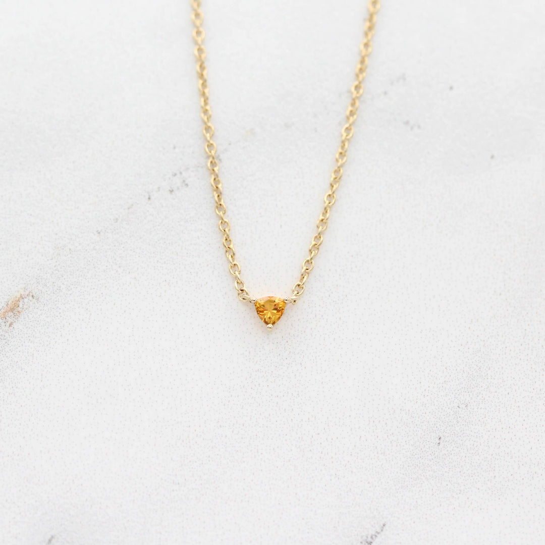 The November Birthstone Tiny Trillion Necklace with Gold Sapphire in Yellow Gold against a white background