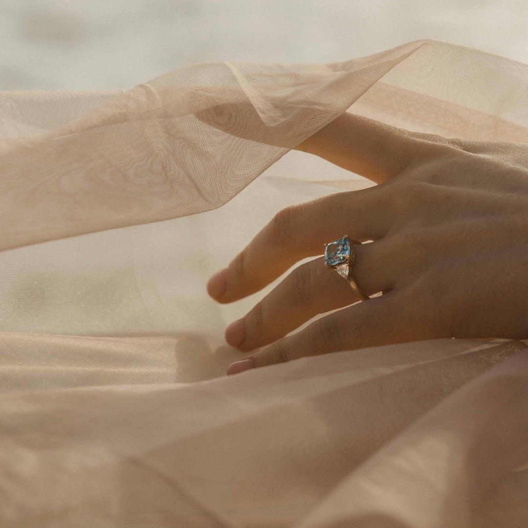 The Izzy Ring (Cushion) with 3.12ct Blue Lab-Grown Diamond in Yellow Gold modeled on a hand