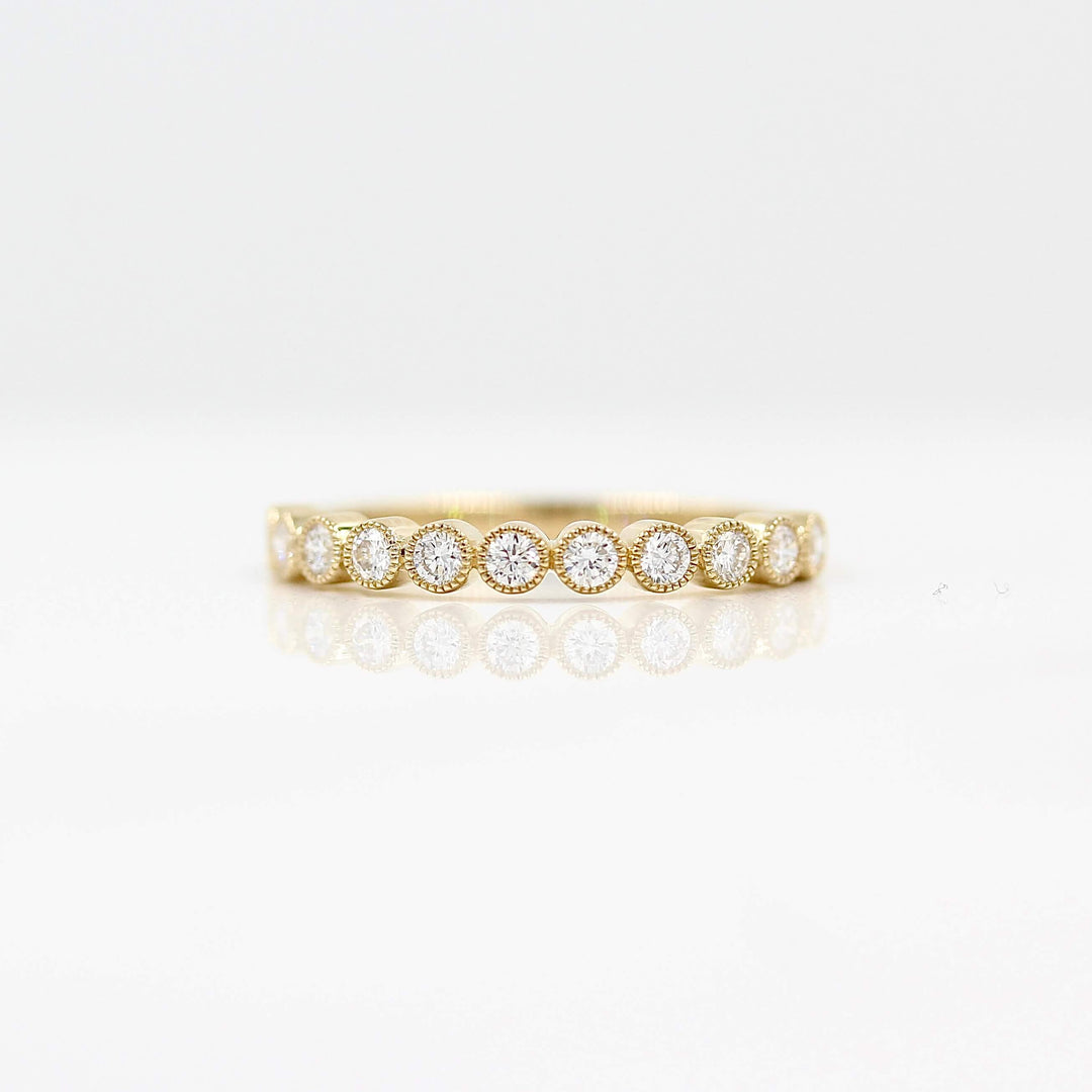 The Jackie Wedding Band in Yellow Gold against a white background
