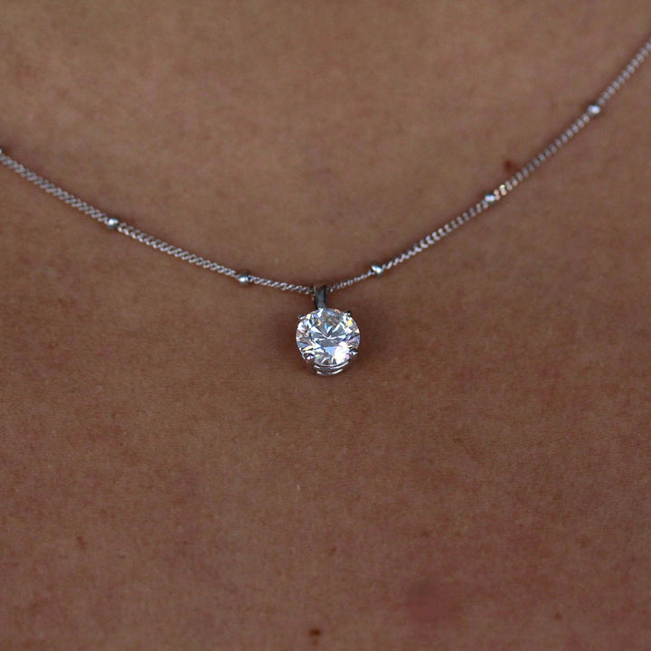 The Janelle Necklace in white gold modeled on a neck