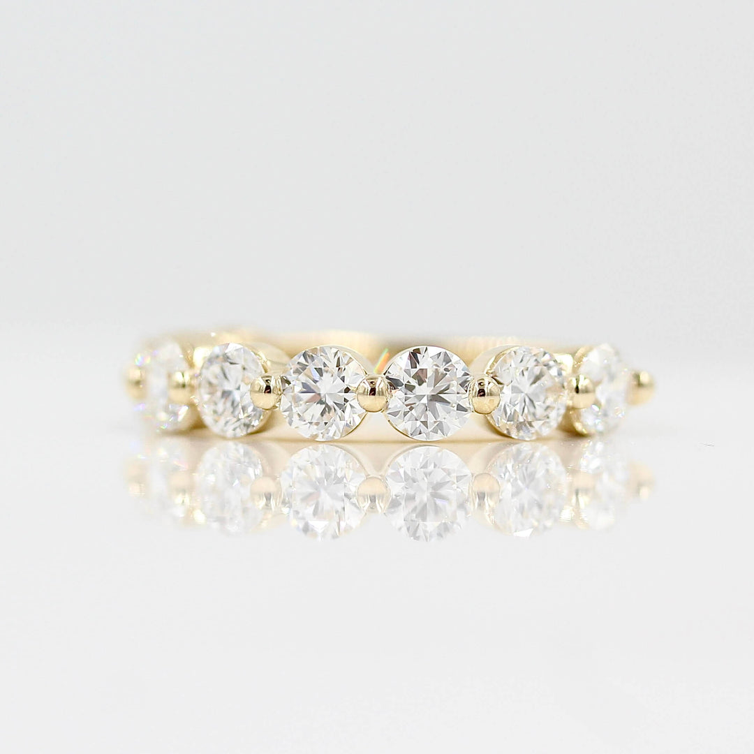 The Melody Wedding Band in Yellow Gold against a white background