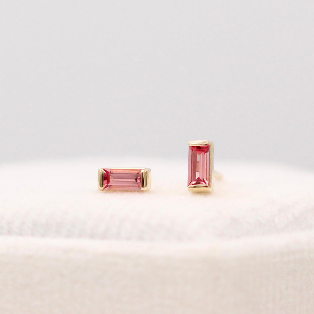 The January Birthstone Baguette Earrings with Padparadscha Sapphire in Yellow Gold against a white background