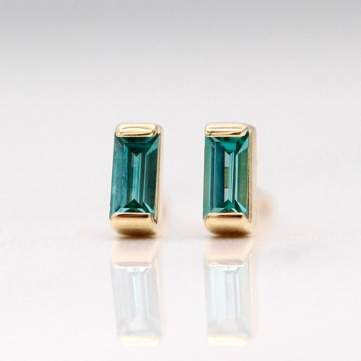 The December Birthstone Baguette Earrings with Paraiba Spinel in Yellow Gold  against a white background