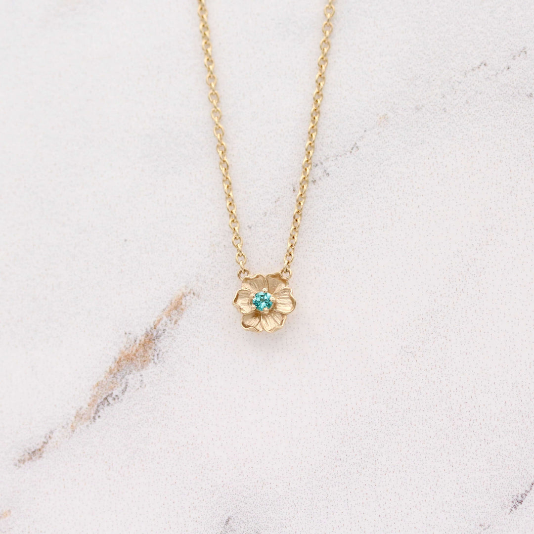 The December Birthstone Poppy Necklace with Paraiba Spinel in Yellow Gold against a white background