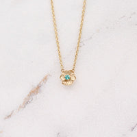 The December Birthstone Poppy Necklace with Paraiba Spinel in Yellow Gold against a white background