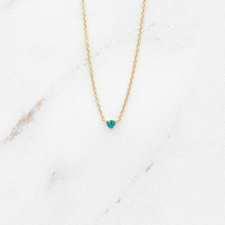 The December Birthstone Tiny Trillion Necklace with Paraiba Spinel in Yellow Gold against a white background