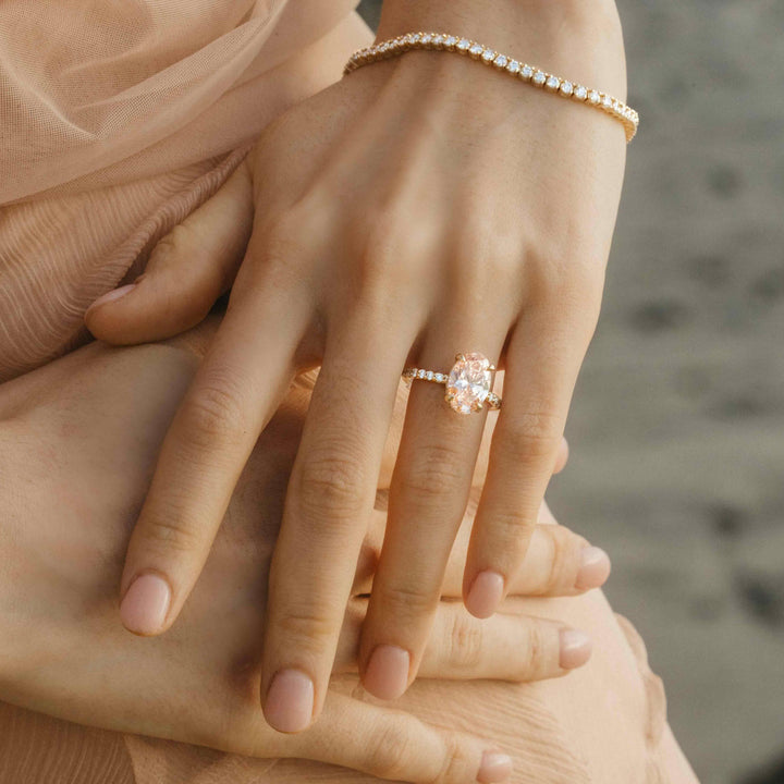 The Athena Hidden Halo Ring (Oval) in Yellow Gold with 3.23ct Pink Lab-Grown Diamond modeled on a hand