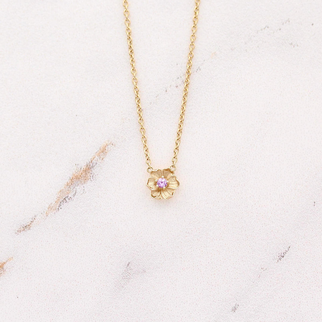 The February Birthstone Poppy Necklace with Purple Sapphire in Yellow Gold against a white background