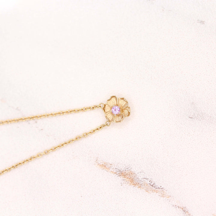 The February Birthstone Poppy Necklace with Purple Sapphire in Yellow Gold against a white background