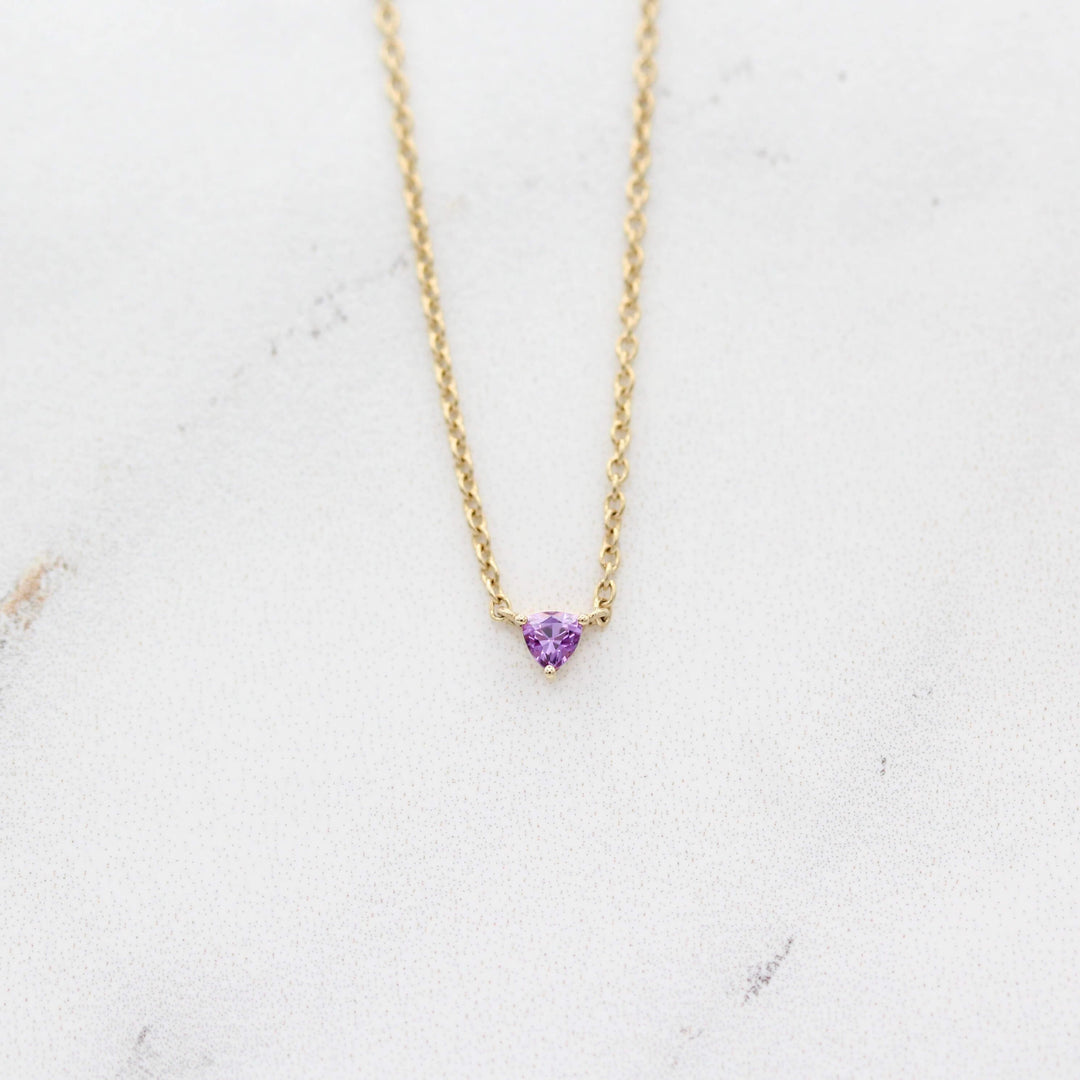 The February Birthstone Tiny Trillion Necklace with Purple Sapphire against a white background