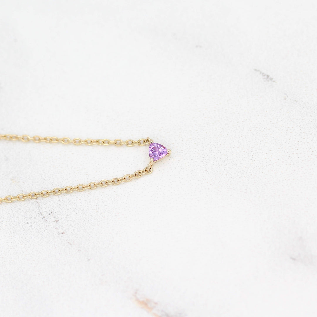 The February Birthstone Tiny Trillion Necklace with Purple Sapphire against a white background