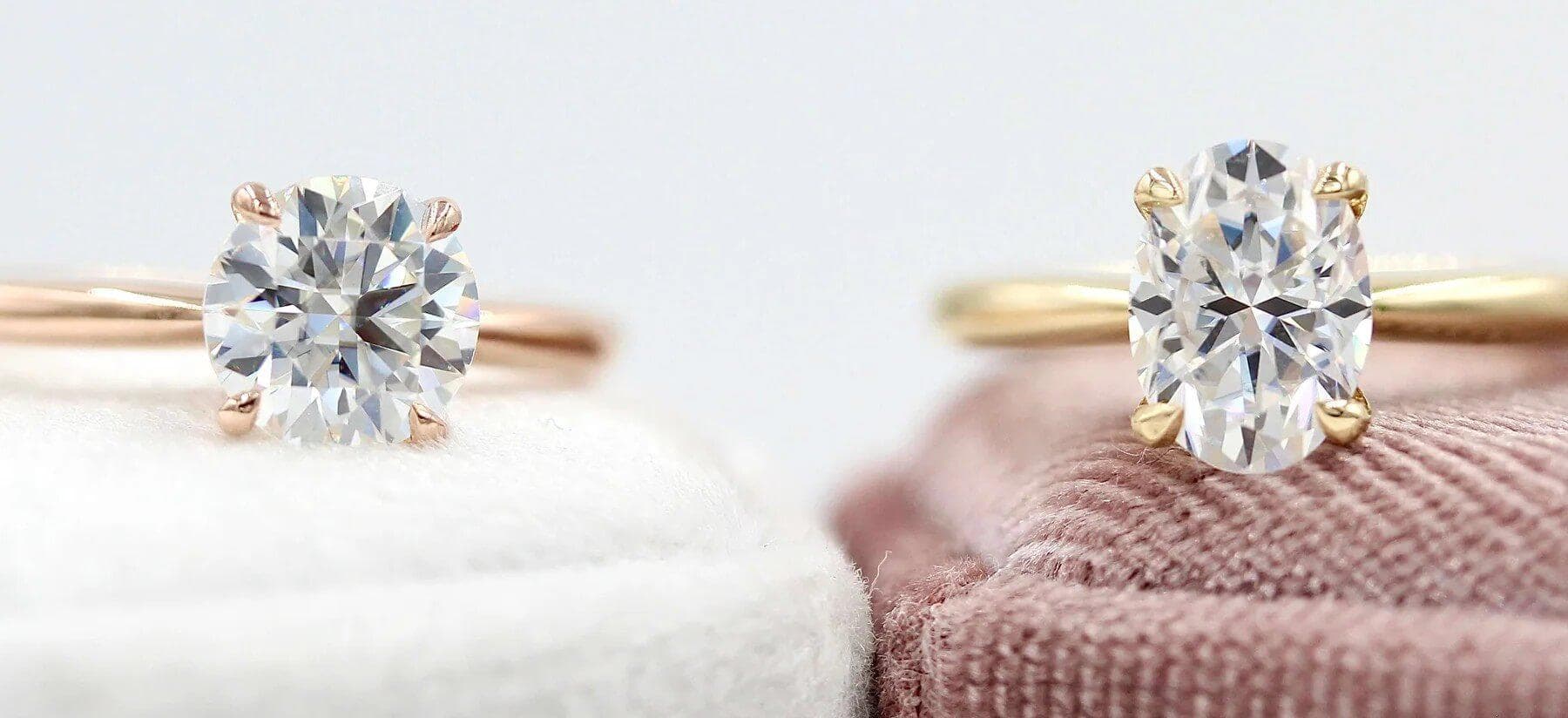 two lab-grown diamond engagement rings sitting on ring boxes