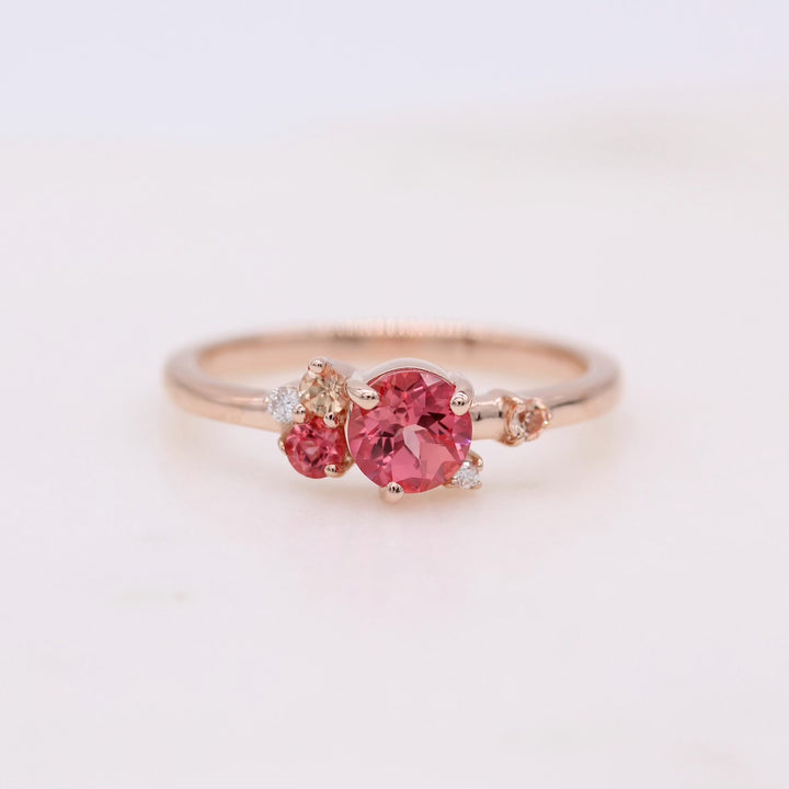 pink sapphire cluster ring on white background