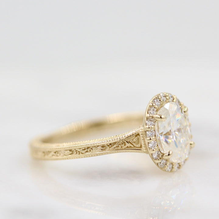 side view of a gold oval engagement ring